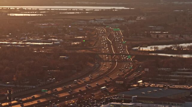 Cars and trucks driving on a busy american highway during a beautiful sunset in the late afternoon 4K denver