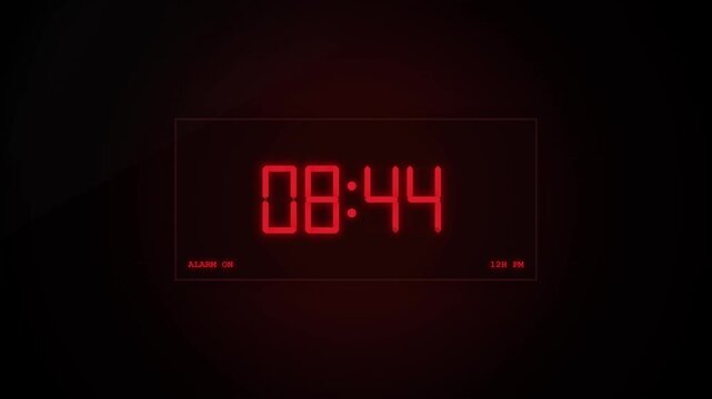 Digital alarm clock with glowing red numbers on dark background showing time passing