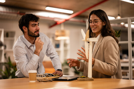 Engineers discussing wind energy project in office
