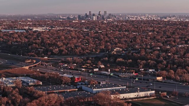 Vast aerial cityscape of denver, colorado, with downtown skyscrapers and suburban highway traffic 4K