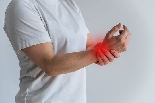 A woman suffers from wrist pain. The source of the pain is depicted as a red spot.