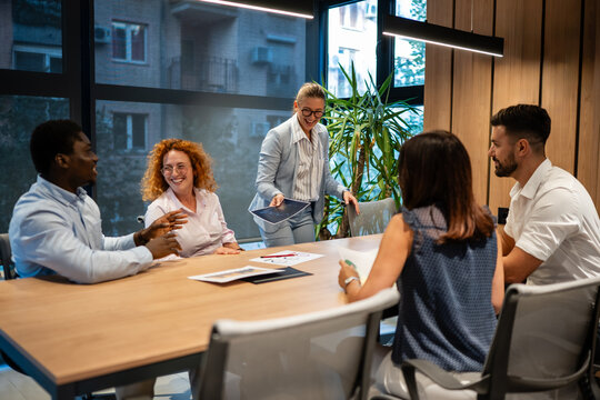 Diverse business team collaborating in modern office meeting