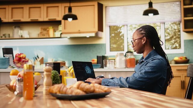 Self-employed woman telecommuting with generative artificial intelligence, focused on analytics and task management on laptop. Deep learning systems and data processing on screen at home.