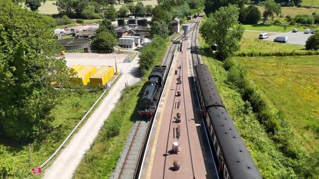 Aerial View of Vintage Steam Train at Rural Railway Station in England