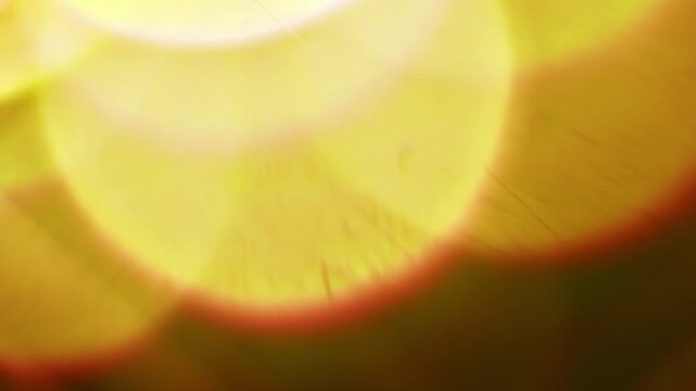 Warm lighting illuminating the brilliance of a reflective prism. Real optical effect of light glowing creating a dreamy bokeh in warm colors. Lens flare and light burst visual effect. Seamless Loop.