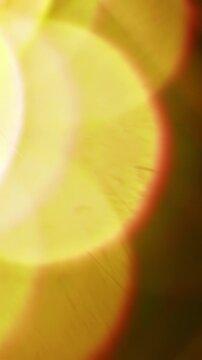 Warm lighting illuminating the brilliance of a reflective prism. Real optical effect of light glowing creating a dreamy bokeh in warm colors. Lens flare and light burst visual effect. Seamless Loop.