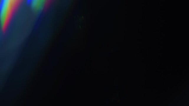 Light ray shining in a glass prism causing a lens flare of dazzling sparkling lights in a rainbow of colors. Reflective streaks of angled lighting for a visual effect of brilliant shining colors Loop