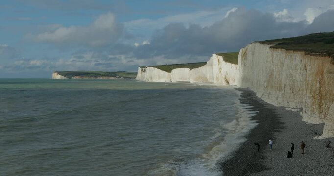 Clouds, waves, sea, beach, people, chalk cliffs Seven Sisters, Birling Gap near Eastbourne, East Sussex, England, Great Britain