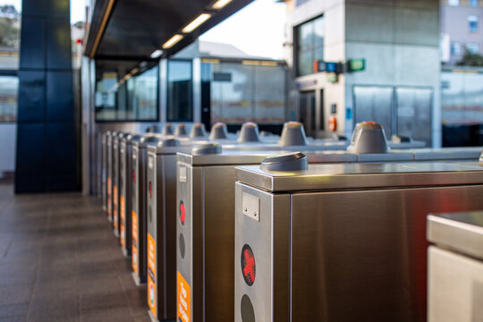 Row of automated ticket barriers and electronic turnstile gates at a modern public transport station