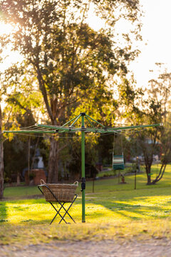 Australian backyard scene of washing line with peg bag and washing basket at sunset