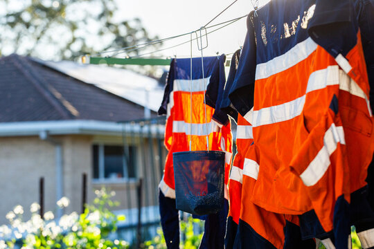 Dark blue peg basket bag hanging on washing line with high visibility workwear in Australia