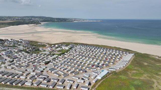 Holiday homes over Hayle Beach and Hayle Estuary from drone, St Ives Bay, Cornwall, England, United Kingdom