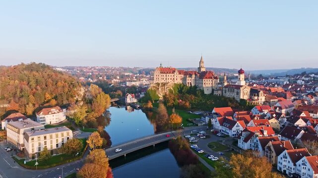 Aerial view of the town of Sigmaringen with the Hohenzollern Castle, a sight and tourist attraction above the old town and the Danube with autumnal vegetation, Danube valley, district of Sigmaringen