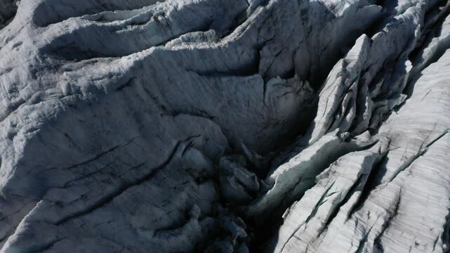 Drone video, detailed view of a glacier with deep cracks and distinctive ice structure, Upper Arctic Sea, high alpine landscape with mountains and glaciers, Oberland, Bern, Switzerland