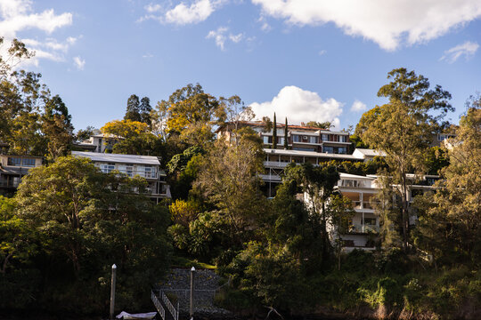 houses on a hill next to water catching the afternoon light