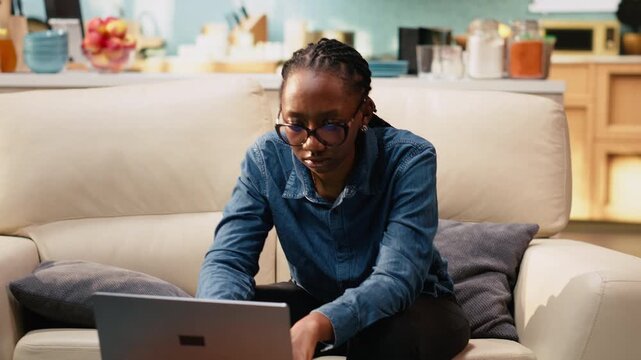Uncertain young woman frowning about ambiguous tasks at home, remote work on laptop indoors, disoriented disorganized freelancer unsure about telecommuting.