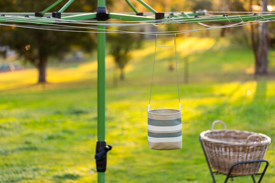 Australian backyard scene of washing line with peg bag and washing basket at sunset