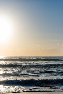 Bright Sun Glare Over Ocean Waves at Beach
