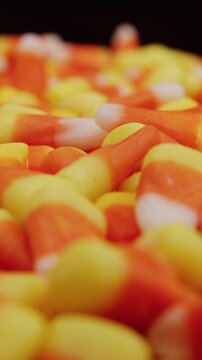Candy corn slow dolly on table shallow depth vertical video