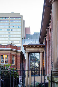 Heritage brick and sandstone architecture framed against modern city towers