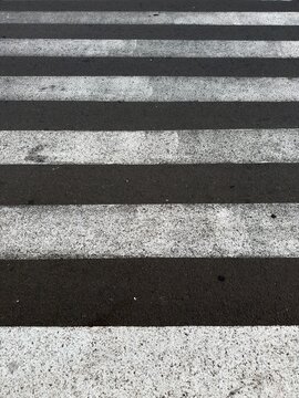 Top view of classic black and white zebra crossing on asphalt road, urban pedestrian crosswalk texture background for design use