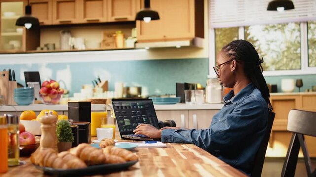 Adult woman using laptop to write programming code and develop software. Programmer focused on debugging scripts, analyzing data and working with terminal window. Digital work environment.
