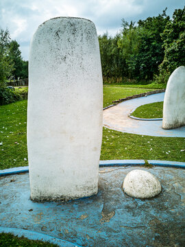 Miniature golf course obstacles with white standing stones and blue borders