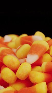 Candy corn pile spinning on turntable closeup vertical video
