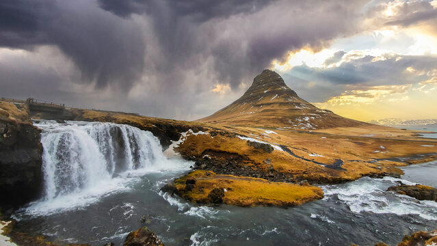 Scenic of Kirkjufell mountains and kirkjufellsfoss at sunrise in Iceland.