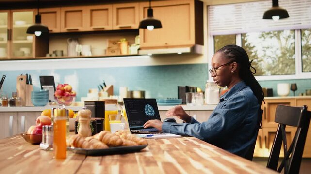 Remote worker uses AI-powered software and laptop with artificial intelligence, neural networks and machine learning for data analysis, while woman telecommutes at home in a lifestyle setting.