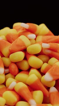 Candy corn pile spinning on turntable vertical video