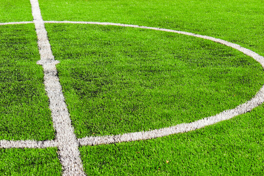green synthetic grass field texture with white boundary line for sport background