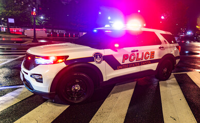 United States Capitol Police SUV at Night. Capitol Police Vehicle with Flashing Lights. Police SUV on City Street. Emergency Police Lights at Night. © Svitlana