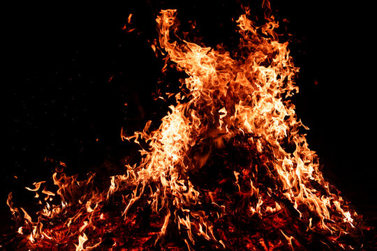 Burn effect with blazing fire. Bonfire embers burn beneath bright flames. Burn effect with glowing embers. Glowing cinders burn beneath bonfire flames.