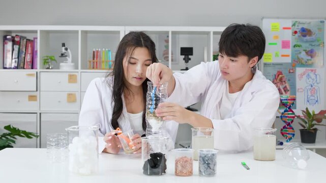 Teenage Students in Lab Coats Conducting Water Filtration Science Experiment