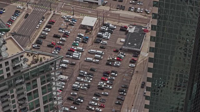 Parking lot bustling with vehicles in a busy urban area forward movement drone video denver colorado 4K