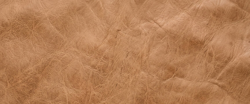 Close-up view of a textured, brown suede leather surface. The material displays a soft, rich appearance with natural creases and variations in color.