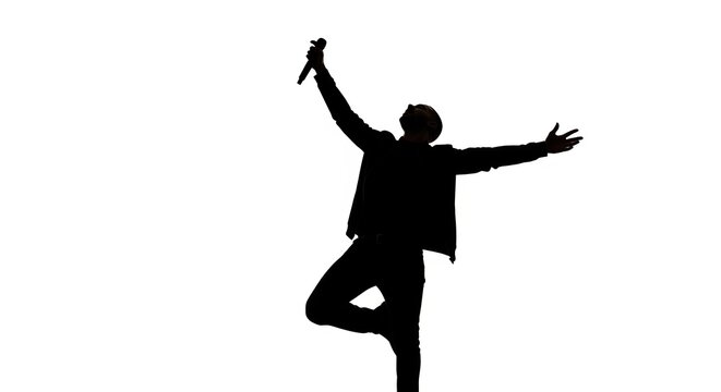 Silhouette of a Performer: A lone performer silhouetted against a bright background, microphone in hand, striking a dramatic pose on stage.