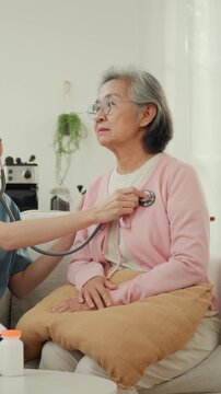 Senior wellness checkup at home, elderly woman receives medical examination with stethoscope, calm patient care, blood pressure monitoring and gentle nurse support