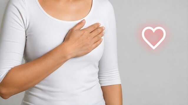 Woman with hand on chest feeling chest discomfort heartburn acid reflux or cardiac trouble medical concept
