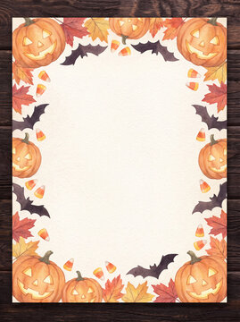 Halloween border card on dark rustic wooden table with pumpkins and bats