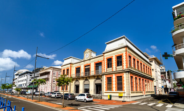 The historic old post office building featuring yellow and red architecture under a blue sky in Fort-de-France, Martinique