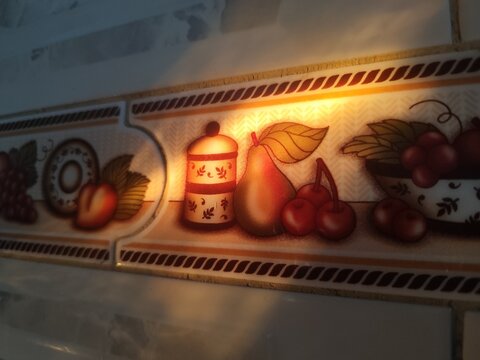 vintage kitchen tile featuring an illuminated still life style design. close up shot
