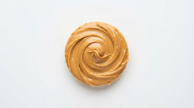 Swirl of creamy peanut butter isolated on white background