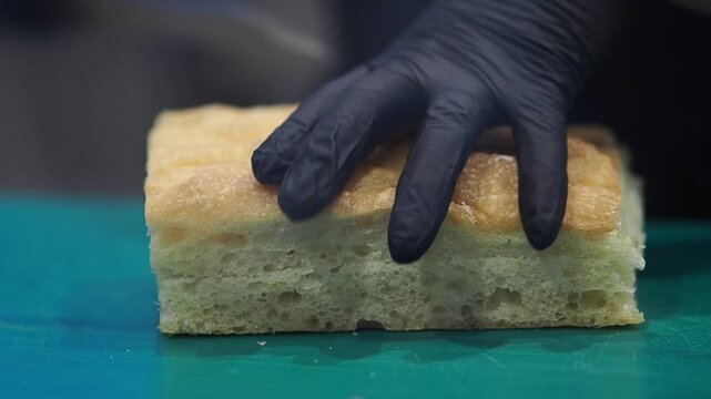 Baking bread using a large piece of dough on a green cutting board