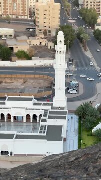 Aerial view of Masjid Al Fath with its white dome, minaret, and courtyard in Medina.