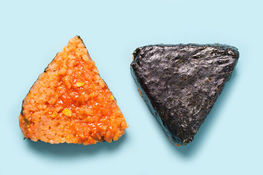 Korean triangle of nori and rice on a blue background close-up.