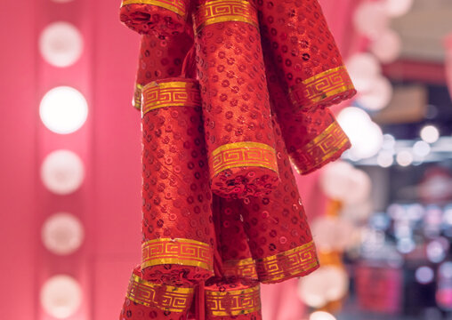 Decorative red firecrackers with shining sequins and gold bands for a vibrant holiday celebration