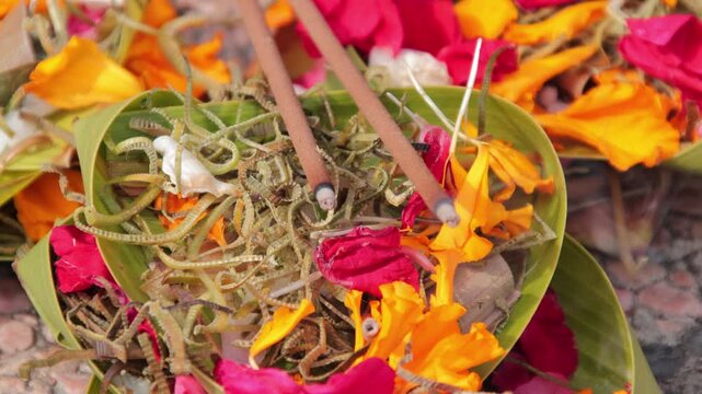Balinese Hindu Offering Canang Sari with Incense Sticks and Flowers