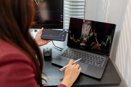 Professional investor monitoring financial markets and analyzing investment opportunities in a modern office, representing stock trading, market research, portfolio management.